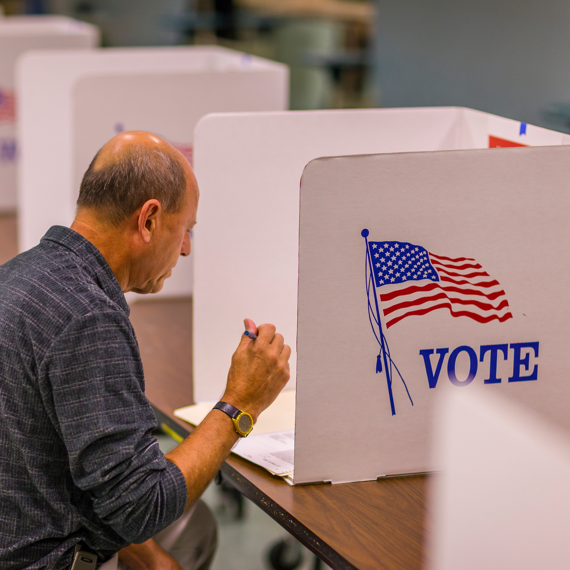 Man voting at a voting booth